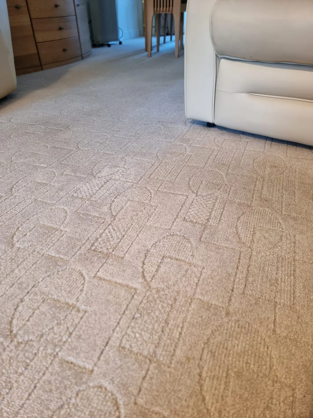 A patterned cream lounge carpet cleaned back to an even colour, with fresh vacuum lines running across the pile